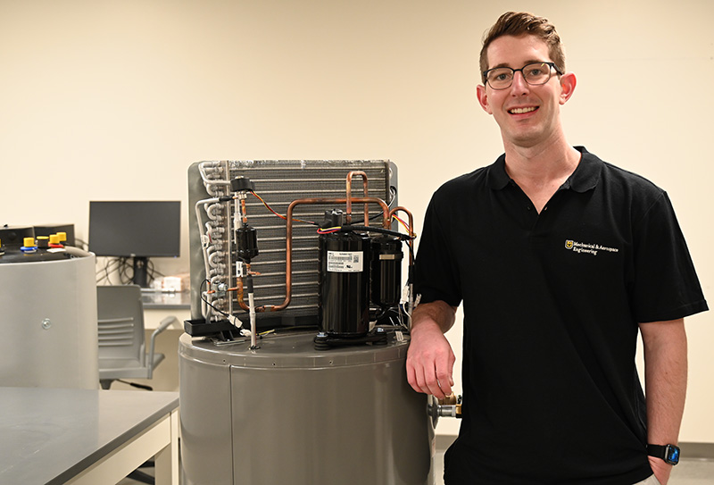 A Ph.D. student stands in a lab