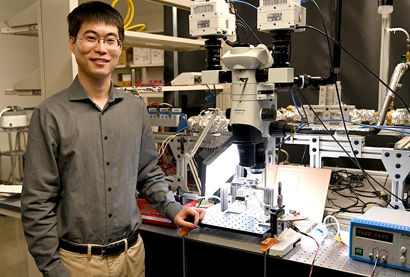 A researcher posing in a lab