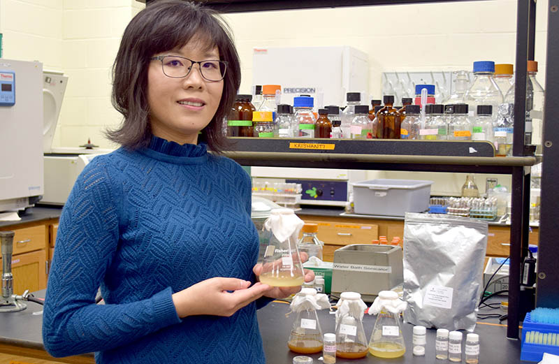 A researcher holding a beaker